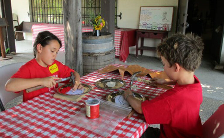 2 kids doing crafts at Wild West Camp